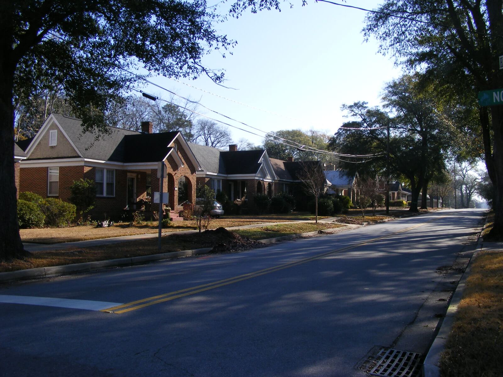 Photograph of a street with brick homes