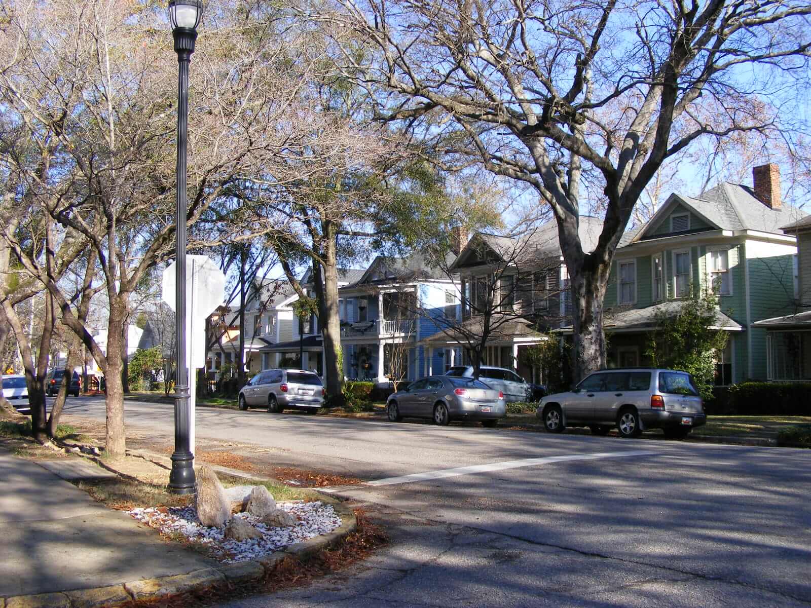 Photograph of a street with two story wood-sided homes