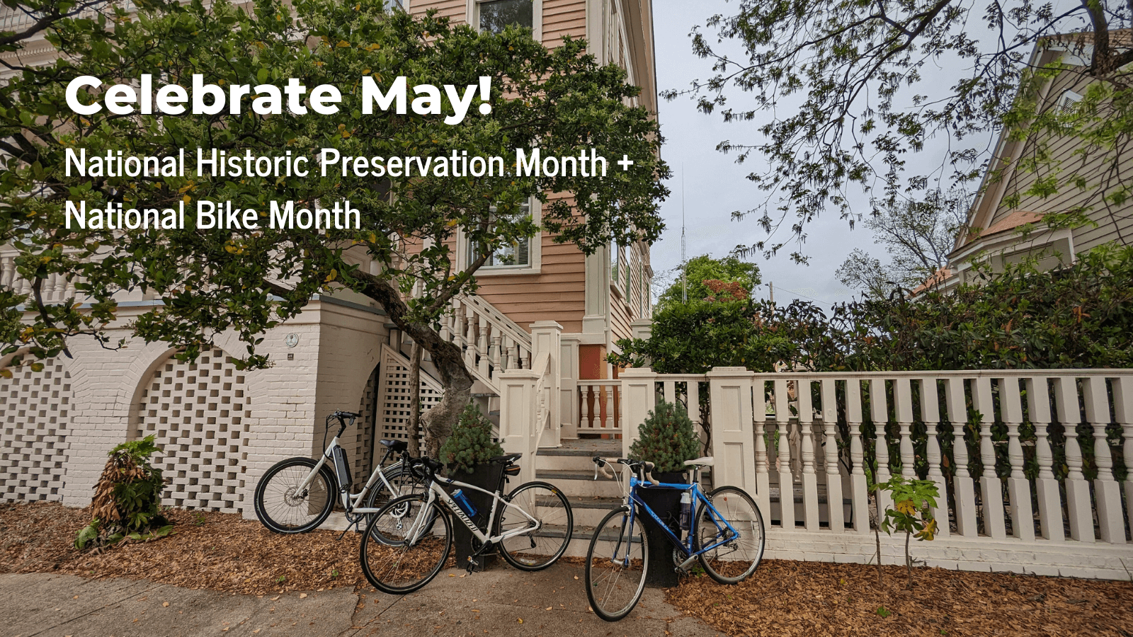A photo of the three bikes leaning against a set of wooden stairs in front of a historic building in downtown Columbia. White text reads: “Celebrate May! National Bike Month & National Historic Preservation Month”