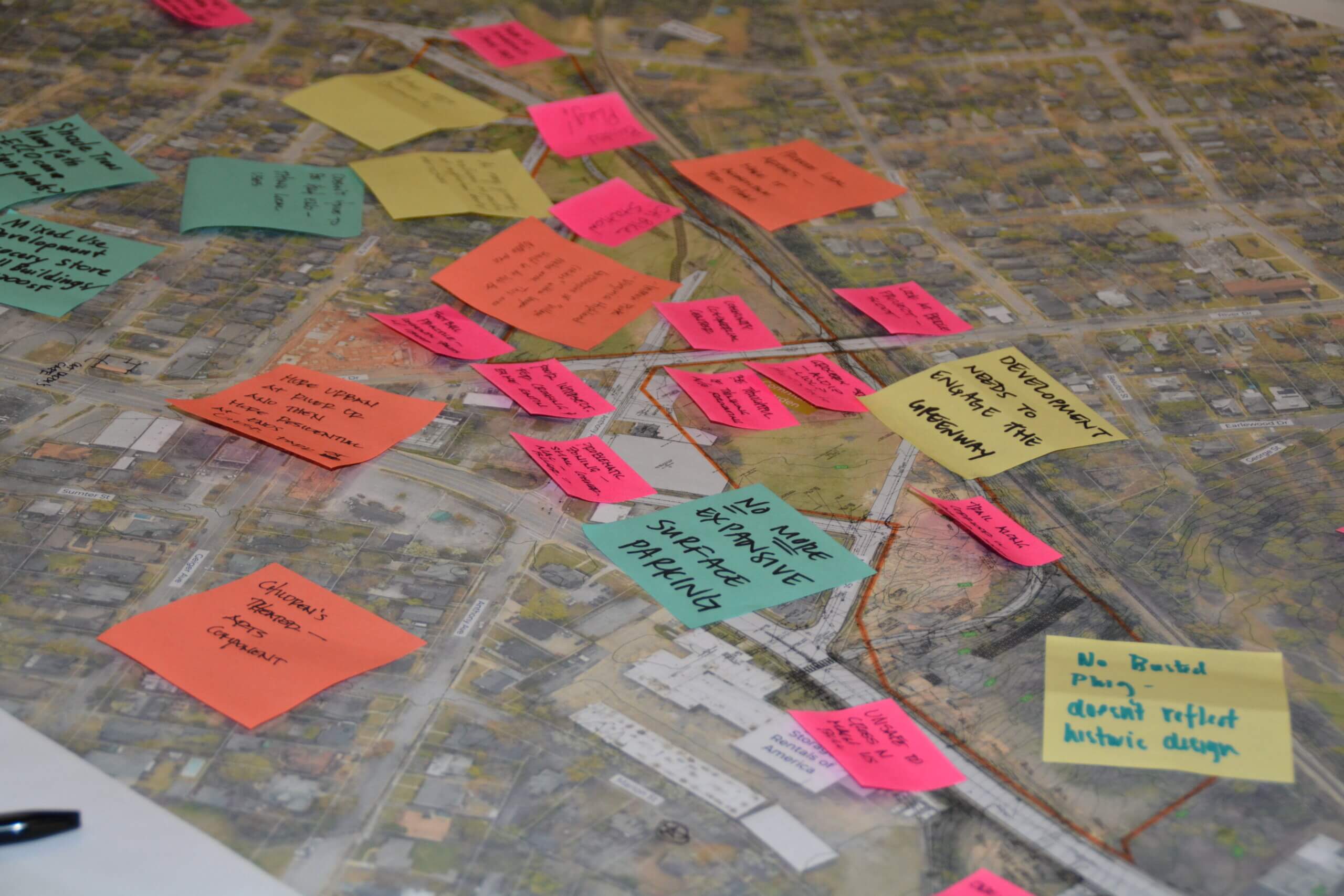 A photo of a map of the former I-277 ROW with sticky notes placed all over it.